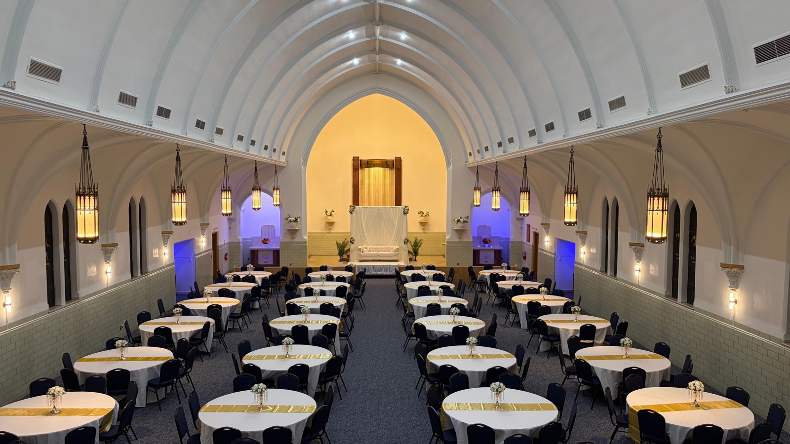 The vaulted hall interior, arched ceiling above rows of banquet tables